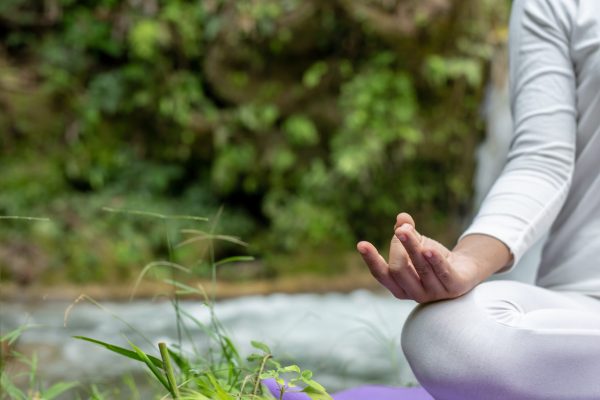 Beautiful girls are playing yoga at the park. Among the natural waterfalls in the forest, exercise concepts